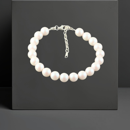 Damen Armband aus weißen schimmernden  Kristallperlen, alle 8mm gross. Mit  Karabinerverschluss und Verlängerungskette von 3cm aus 925 Sterlingsilber. Schmuckmarke Hug the Lioness aus Österreich.