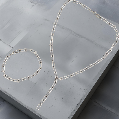 Moderne Y-Kette und Armkette aus Hufeisen-Kettengliedern mit kleinen Kugeldetails. Edelstahlschmuck in minimalistischem Design. Kette und Armkette haben ein klares puristisches Design. Länge 43cm mit Y-Anhängerteil. Armkette 19cm. Die Abbildung des Sets dient nur der Veranschaulichung, der Preis bezieht sich auf die Halskette.
